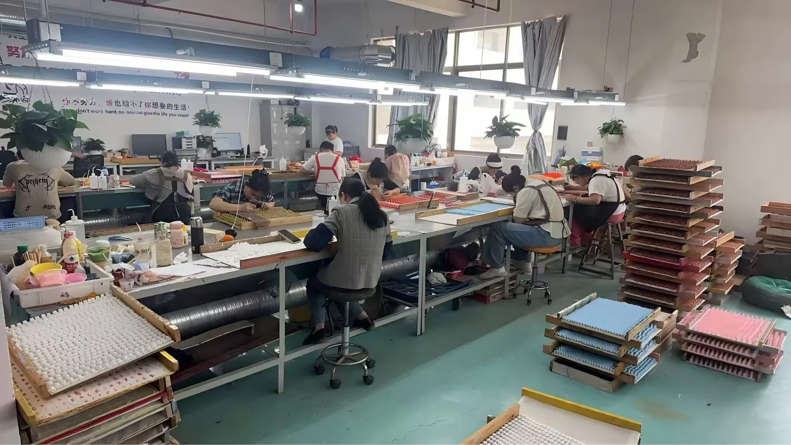 Production workshop with staff working at long tables